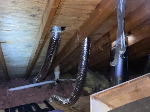 Crawlspace with pipes hanging from the ceiling