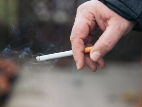 closeup of a hand holding a cigarette