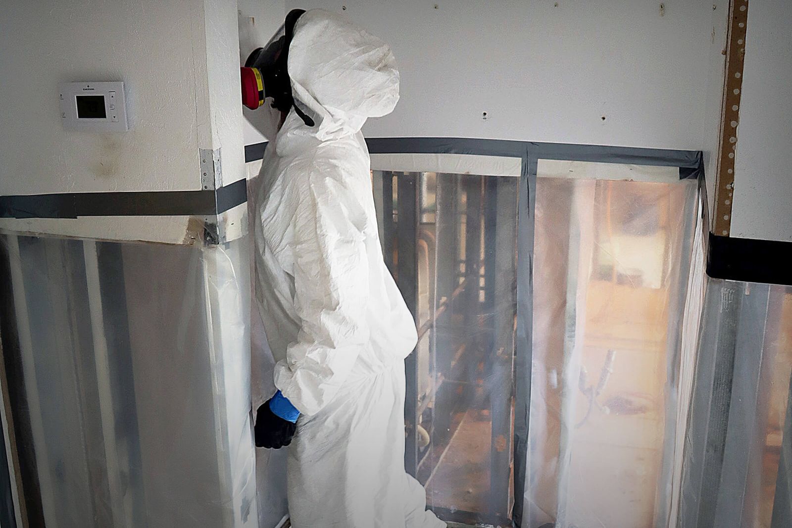 Pur360 Technician in a hazmat suit working on mold remediation