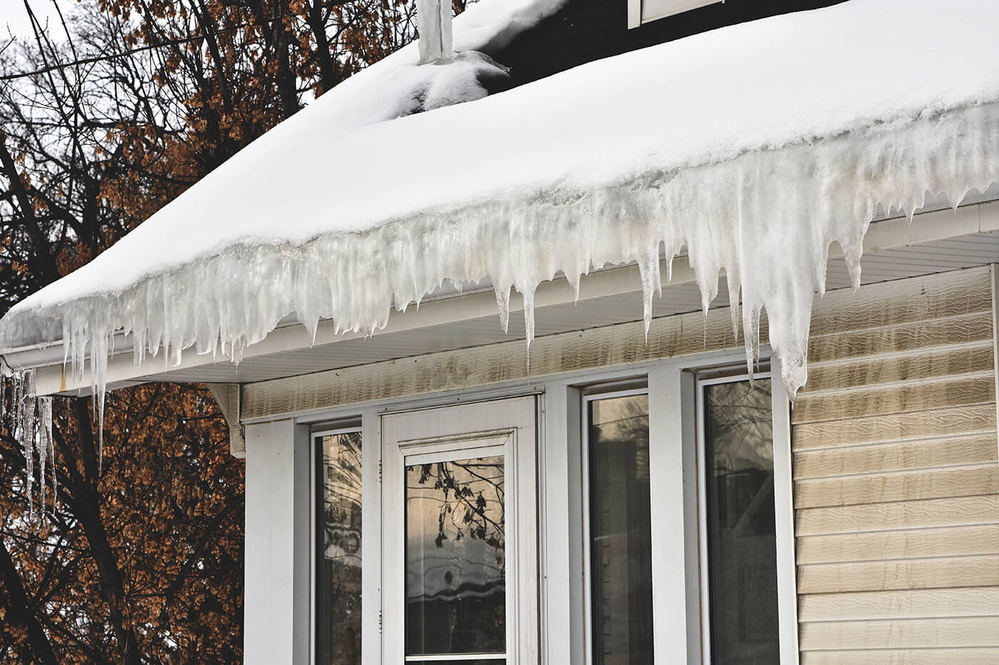 A house with lots of ice and snow on it